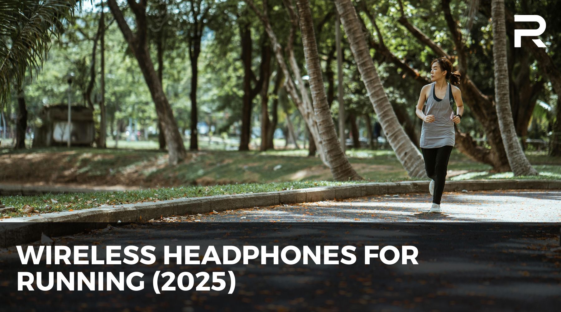 Woman jogging on a park path wearing wireless earphones, promoting wireless headphones for running in 2025 with focus on sport earbuds for runners